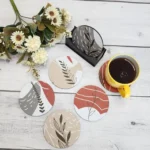 boho-floral-leaf-coaster-set-lifestyle-coffee-cup-white-wood