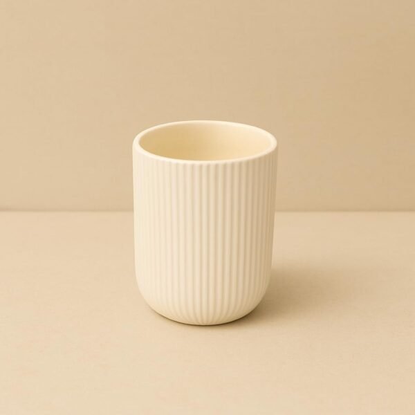 Ivory ribbed ceramic planter with compact round shape and vertical textured finish