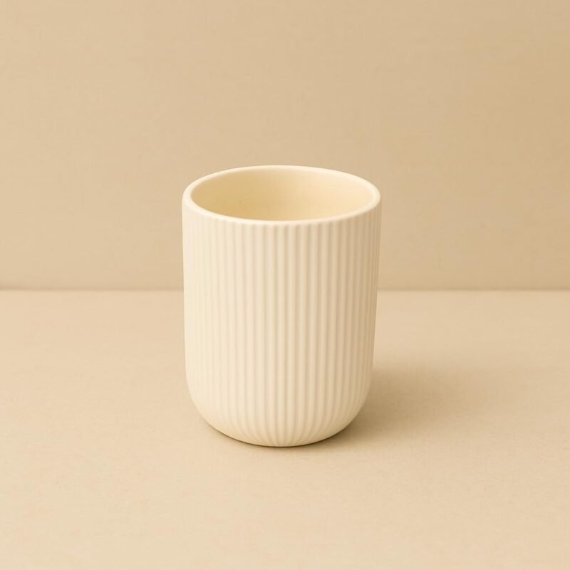 Ivory ribbed ceramic planter with compact round shape and vertical textured finish