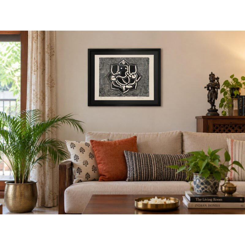 Framed Ganesha woodcut wall art styled above sofa in living room